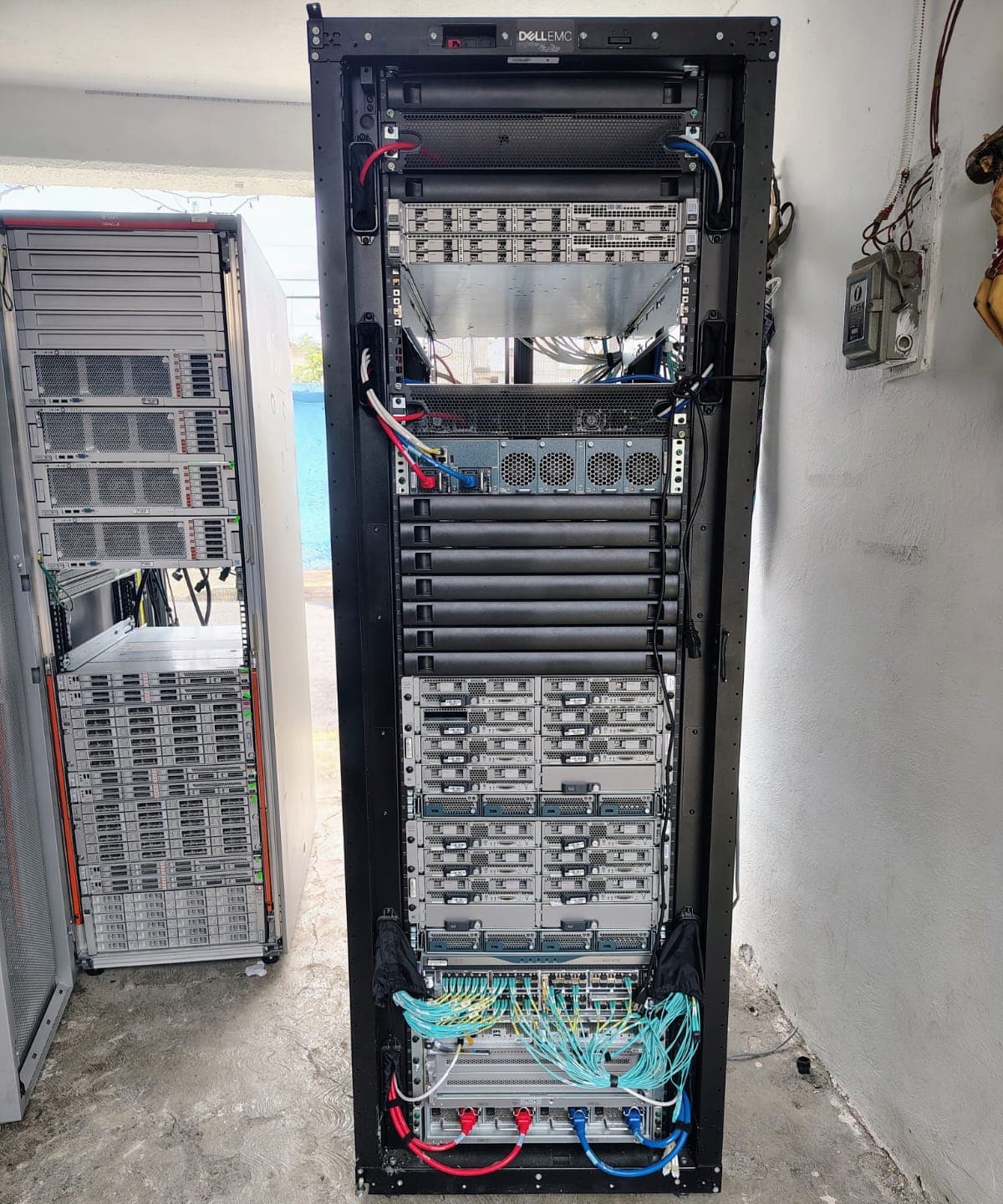 Rack de servidores con cableado de red en el site de un cliente, antes de su retiro